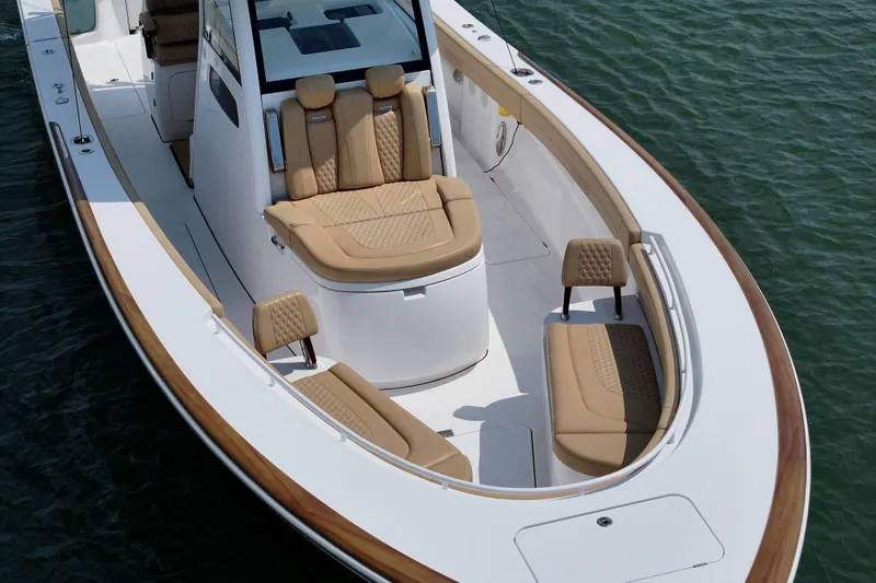 Slide: The Image of Luxurious 2023 Phenom 34 boat with elegant tan seating on calm water. - 15