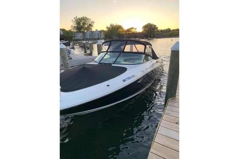 Slide: The Image of 2005 Sea Ray 290 SLX boat docked at sunset, calm waters, scenic background. - 6