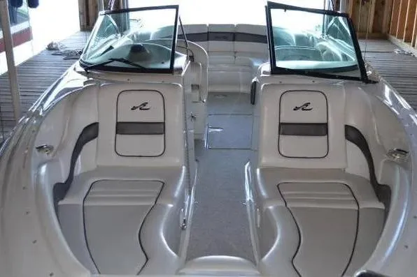 Slide: The Image of 2005 Sea Ray 290 SLX boat interior with dual seating and open windshield. - 14