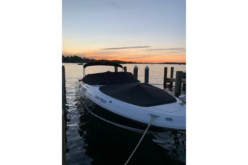Slide: The Image of 2005 Sea Ray 290 SLX boat docked at sunset, calm waters, scenic view. - 5