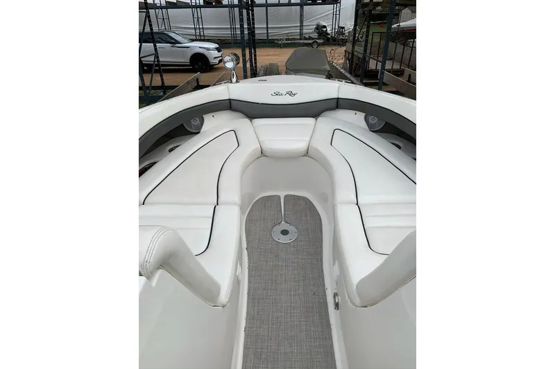 Slide: The Image of 2005 Sea Ray 290 SLX boat interior with white seating and gray flooring. - 12