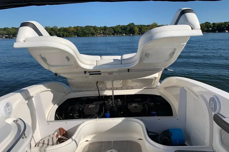 Slide: The Image of 2005 Sea Ray 290 SLX boat with open engine compartment on a serene lake. - 20