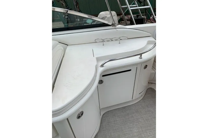 Slide: The Image of 2005 Sea Ray 290 SLX boat interior with white seating and storage compartments. - 8