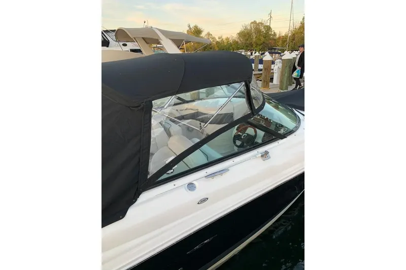 Slide: The Image of 2005 Sea Ray 290 SLX boat with black canopy docked at marina. - 4