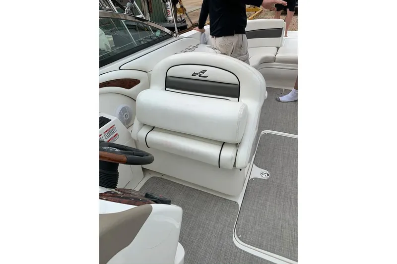 Slide: The Image of 2005 Sea Ray 290 SLX boat interior with white seating and steering wheel. - 15