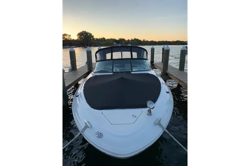 Slide: The Image of 2005 Sea Ray 290 SLX boat docked at sunset, front view. - 2