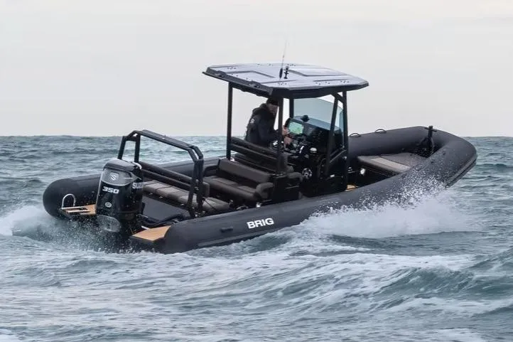 Slide: The Image of Manufacturer Provided Image: 2026 Brig Navigator 26 boat navigating through ocean waves, featuring a powerful 350 engine. - 2