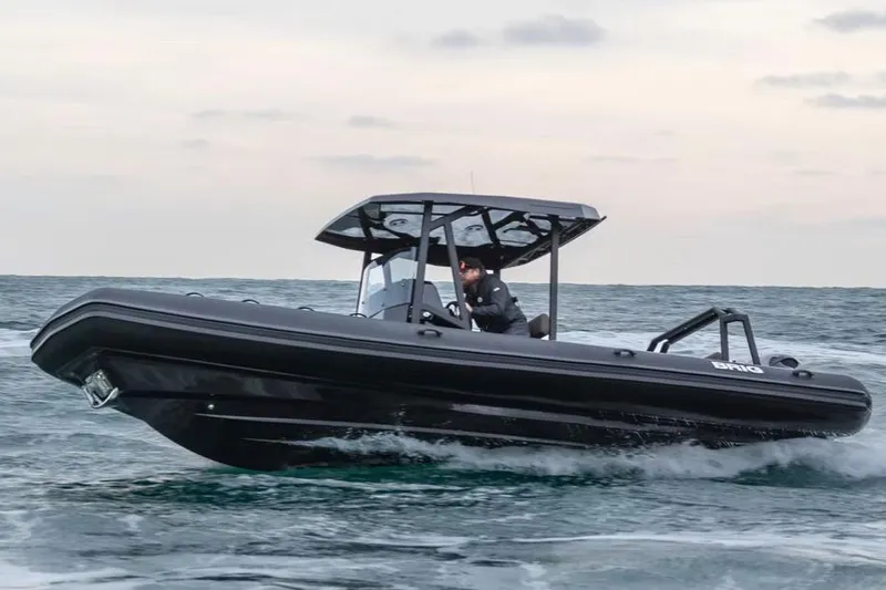 Slide: The Image of Manufacturer Provided Image: 2026 Brig Navigator 26 boat cruising on open water under a cloudy sky. - 1
