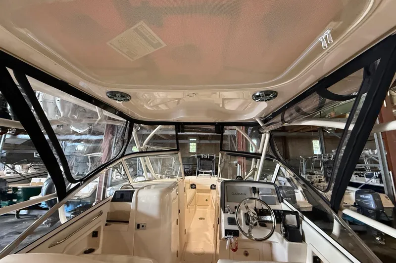 Slide: The Image of Interior view of 2021 Grady-White Freedom 275 boat with steering console and seating. - 21