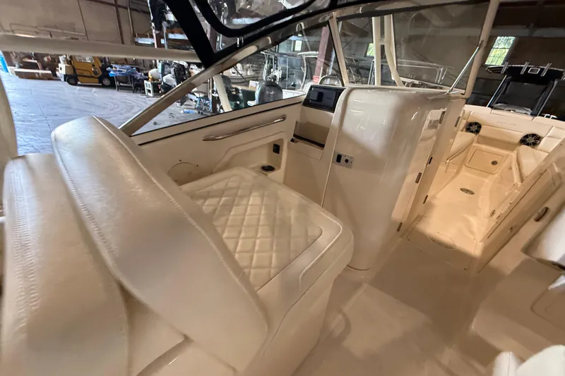 Slide: The Image of 2021 Grady-White Freedom 275 boat interior with luxurious seating and modern dashboard. - 19