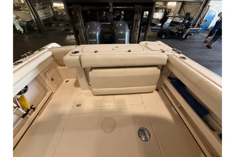 Slide: The Image of The image shows the cockpit of a Grady-White Freedom 275 boat with two outboard engines. - 20