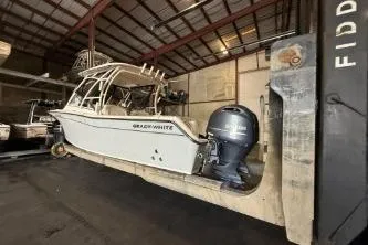 Slide: The Image of 2021 Grady-White Freedom 275 boat in storage facility, side view. - 2