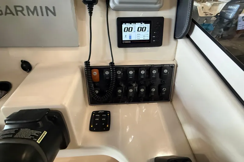 Slide: The Image of Control panel of a 2021 Grady-White Freedom 275 boat with Yamaha display and switches. - 14