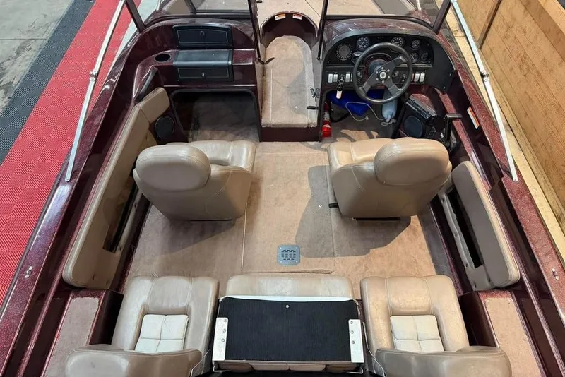 Slide: The Image of 1997 Astro 2050 FSX boat interior with beige seats and dashboard view. - 4