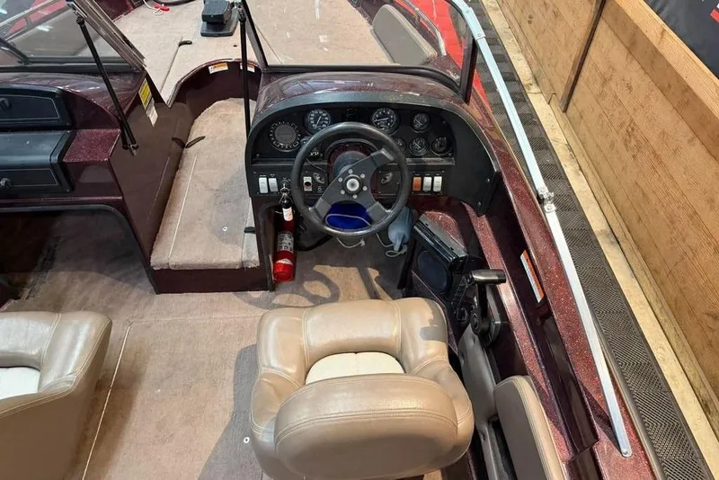 Slide: The Image of Interior of a 1997 Astro 2050 FSX boat with steering wheel and dashboard controls. - 2