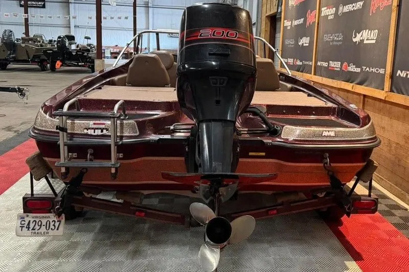 Slide: The Image of 1997 Astro 2050 FSX boat with powerful 200 HP engine in showroom setting. - 8