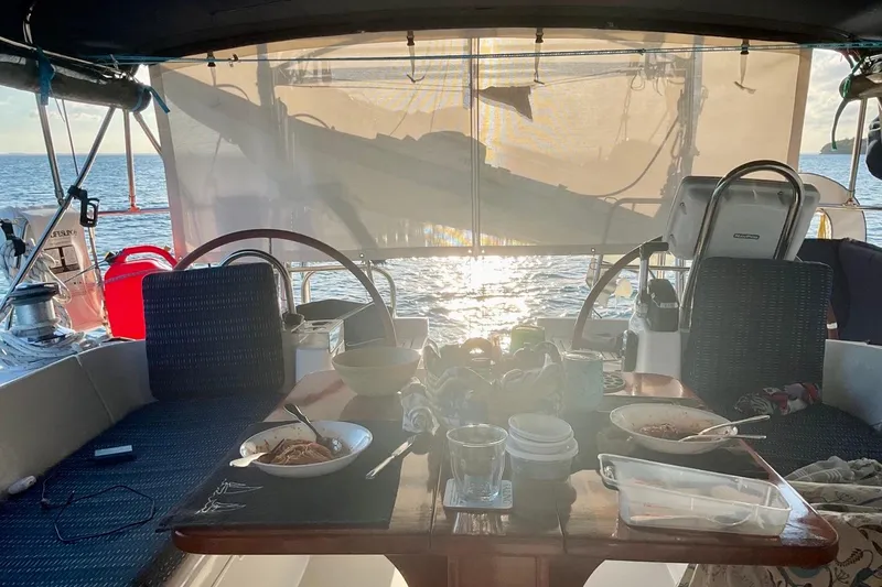 Slide: The Image of Cockpit dining on 2002 Beneteau Oceanis Clipper 473 sailboat at sunset. - 10