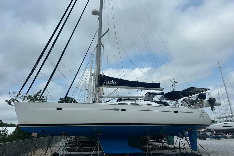 Slide: The Image of 2002 Beneteau Oceanis Clipper 473 sailboat on stands, under cloudy sky. - 7