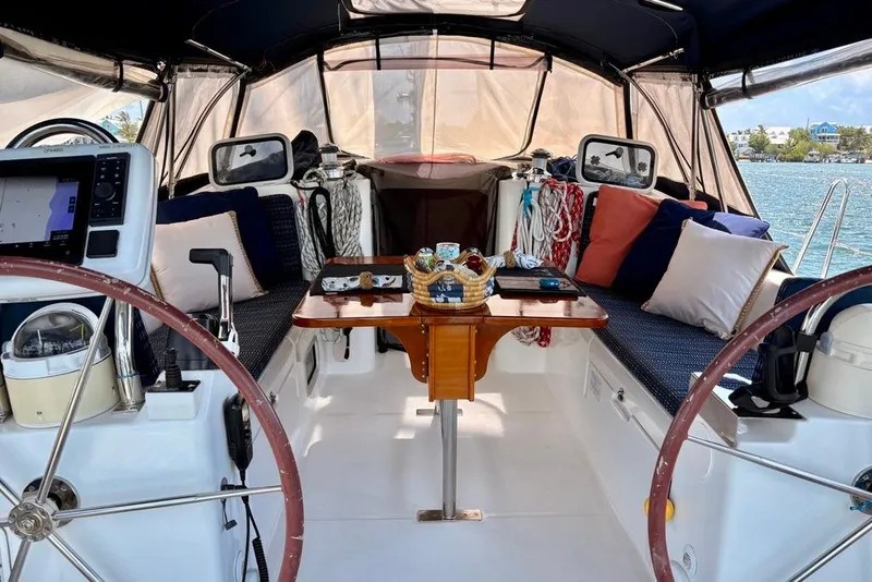 Slide: The Image of Cockpit of 2002 Beneteau Oceanis Clipper 473 yacht with dual steering wheels and cozy seating. - 9