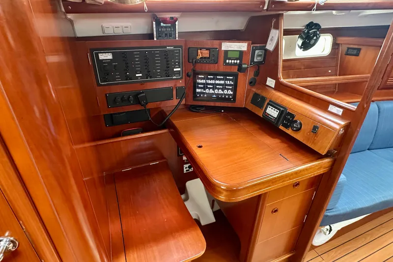 Slide: The Image of Navigation station of 2002 Beneteau Oceanis Clipper 473 yacht with control panels and seating. - 22