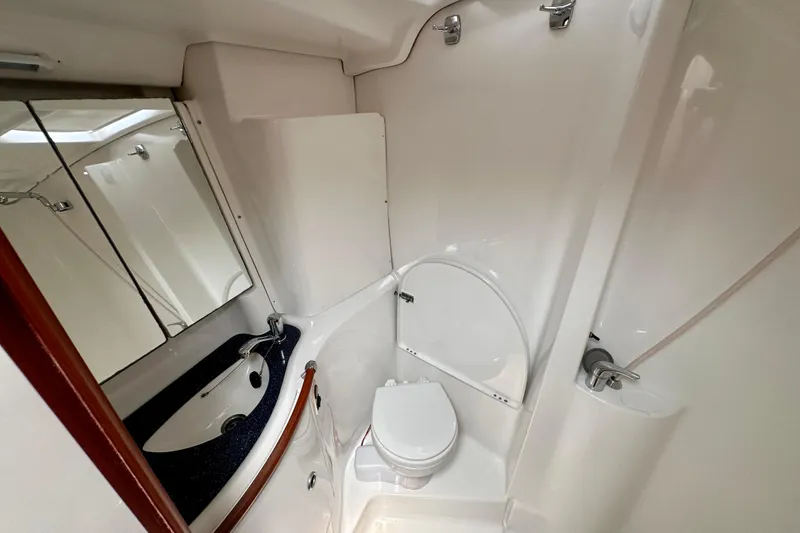 Slide: The Image of Beneteau Oceanis Clipper 473 2002 yacht bathroom with sink, toilet, and mirror. - 32