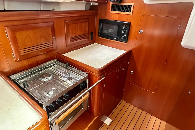 Slide: The Image of Galley kitchen in 2002 Beneteau Oceanis Clipper 473 yacht with stove and microwave. - 27