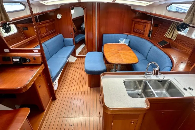 Slide: The Image of Interior of 2002 Beneteau Oceanis Clipper 473 yacht with wood finish and blue seating. - 20