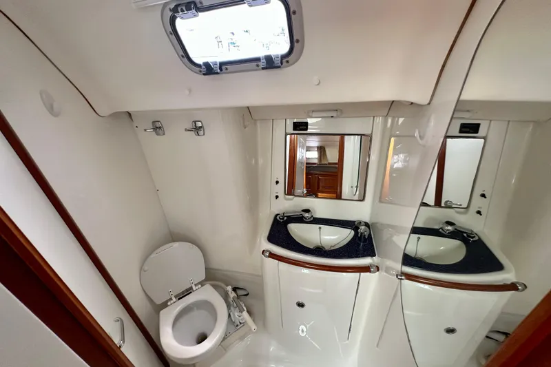 Slide: The Image of Bathroom interior of 2002 Beneteau Oceanis Clipper 473 yacht, featuring sink and toilet. - 31