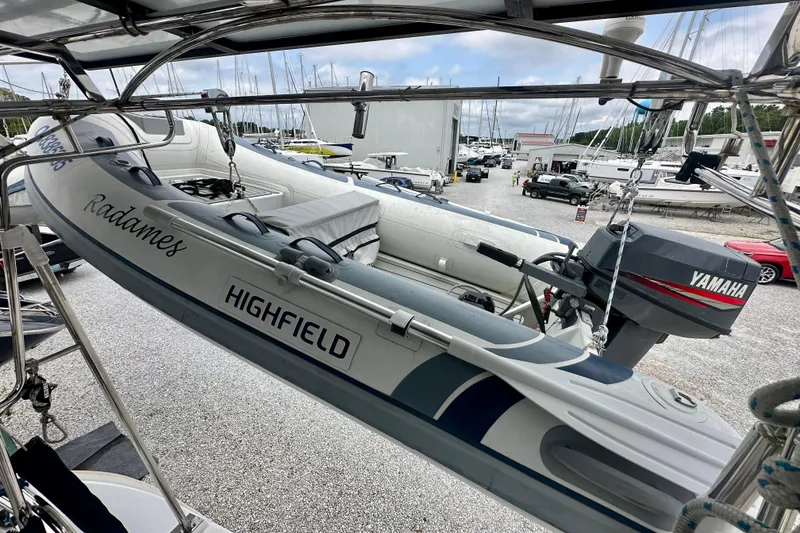 Slide: The Image of Highfield dinghy with Yamaha motor on Beneteau Oceanis Clipper 473, 2002 model, in marina setting. - 34