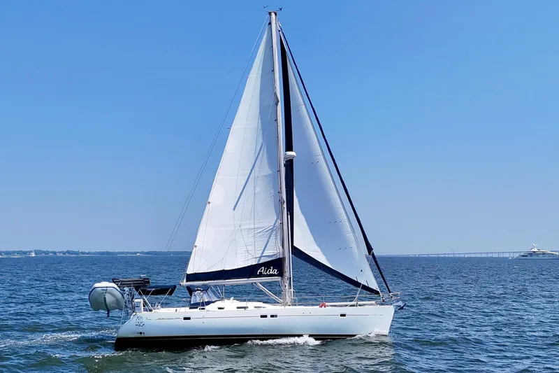 Slide: The Image of 2002 Beneteau Oceanis Clipper 473 sailing on open water under clear blue skies. - 3
