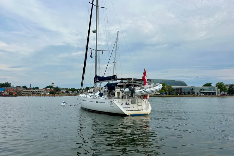 Slide: The Image of Beneteau Oceanis Clipper 473 sailboat anchored in a scenic harbor, 2002 model. - 6