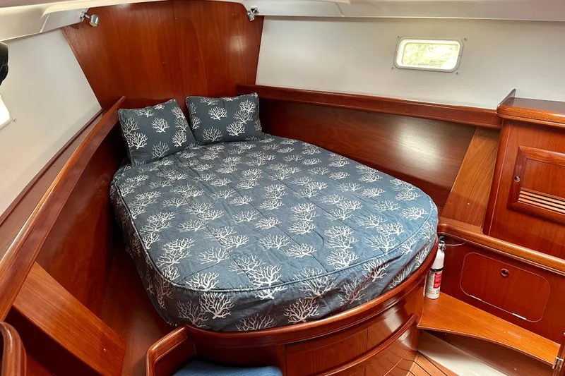 Slide: The Image of Cozy cabin interior of 2002 Beneteau Oceanis Clipper 473 with nautical-themed bedding. - 29
