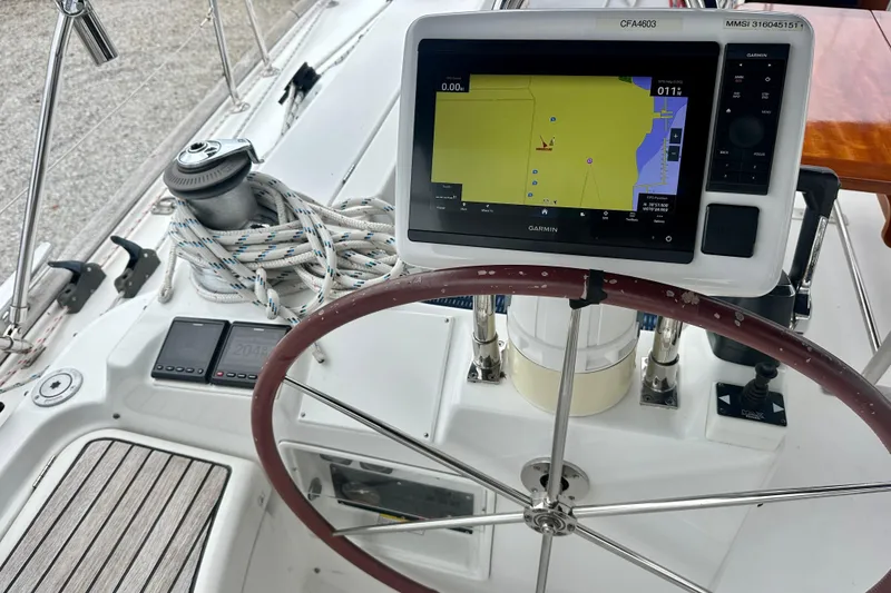 Slide: The Image of Cockpit of 2002 Beneteau Oceanis Clipper 473 with Garmin navigation system and steering wheel. - 13