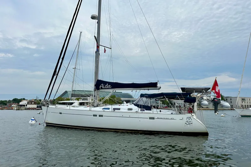 Slide: The Image of 2002 Beneteau Oceanis Clipper 473 sailboat anchored in a calm harbor. - 5