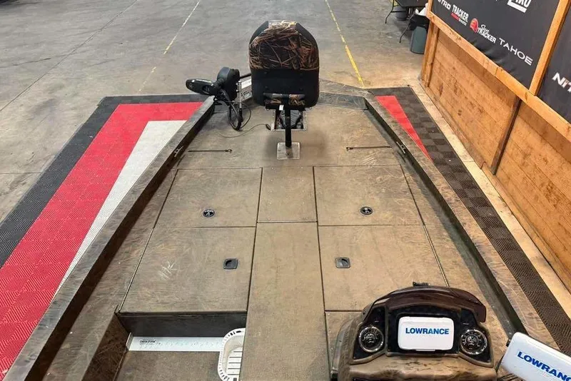 Slide: The Image of 2021 G3 Sportsman 1910 boat interior with Lowrance electronics and camo seating. - 9