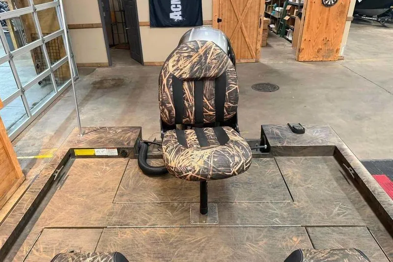 Slide: The Image of 2021 G3 Sportsman 1910 boat interior with camo-patterned seat in a garage setting. - 5