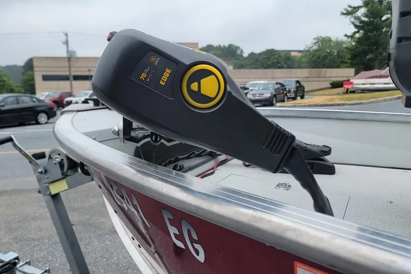 Slide: The Image of Duranautic V-16 boat with trolling motor control, parked outdoors, 2023 model. - 2