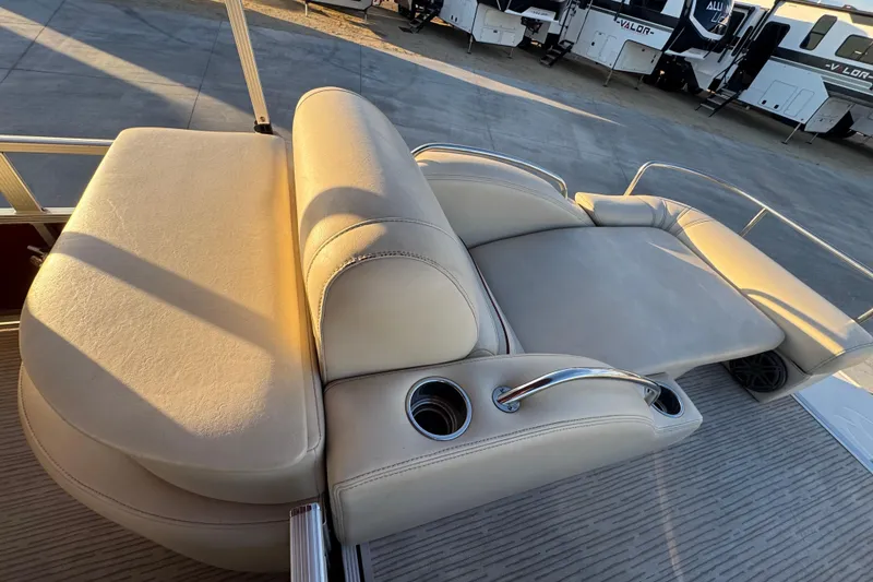 Slide: The Image of Luxurious seating on a 2010 Bennington 2375RL pontoon boat with cup holders. - 17