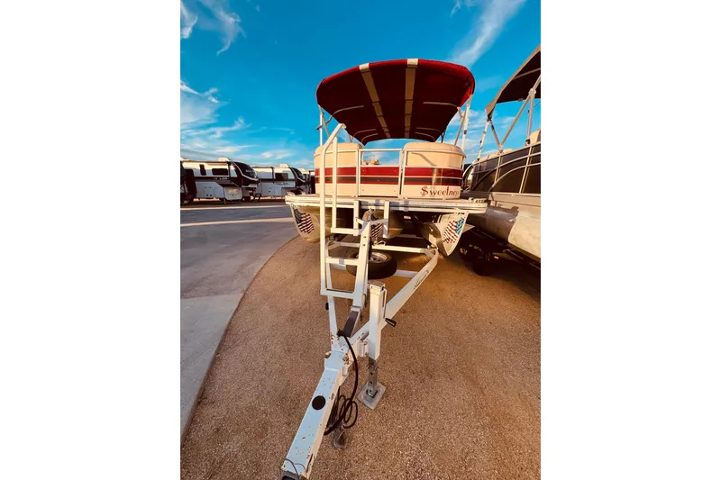Slide: The Image of 2010 Bennington 2375RL pontoon boat on trailer under blue sky. - 6