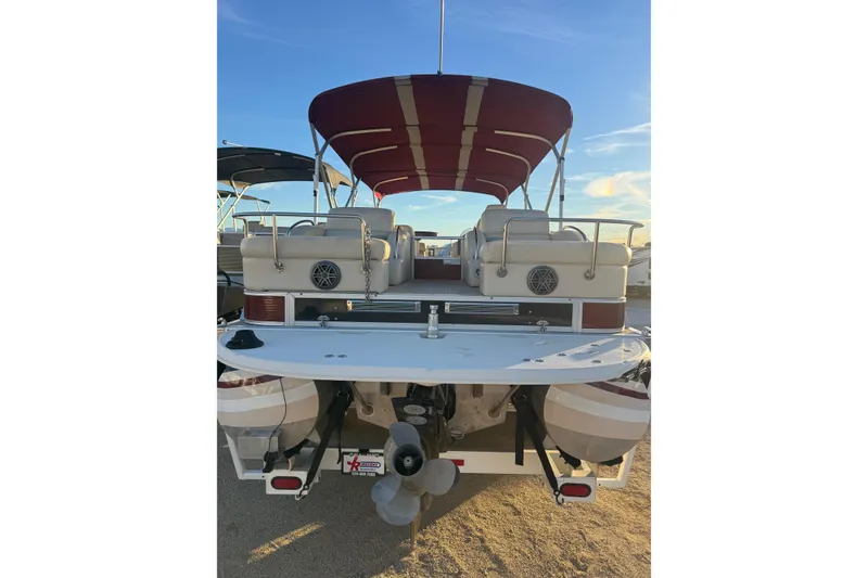 Slide: The Image of 2010 Bennington 2375RL pontoon boat with red canopy and spacious seating. - 3