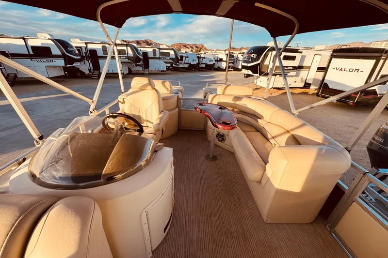Slide: The Image of Interior of a 2010 Bennington 2375RL pontoon boat with beige seating and helm. - 11