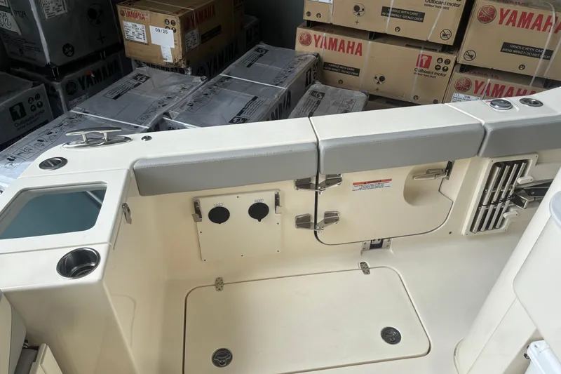 Slide: The Image of 2026 Scout 330 LXF boat interior with Yamaha equipment boxes in background. - 11