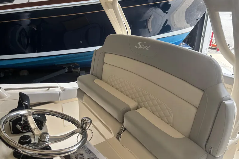 Slide: The Image of 2026 Scout 330 LXF boat interior with luxurious seating and steering wheel. - 17