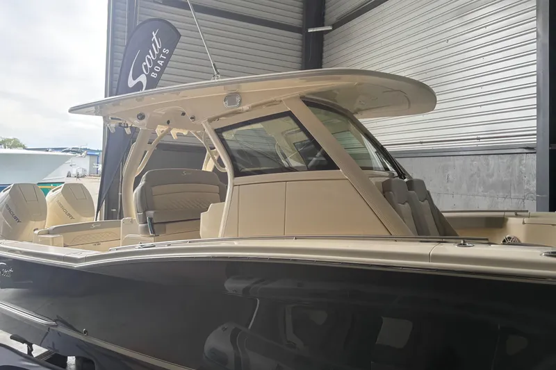 Slide: The Image of 2026 Scout 330 LXF boat in showroom, featuring sleek design and modern amenities. - 5