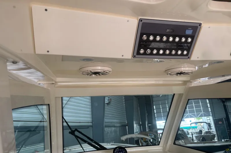 Slide: The Image of Interior view of 2026 Scout 330 LXF boat dashboard with control panel. - 16