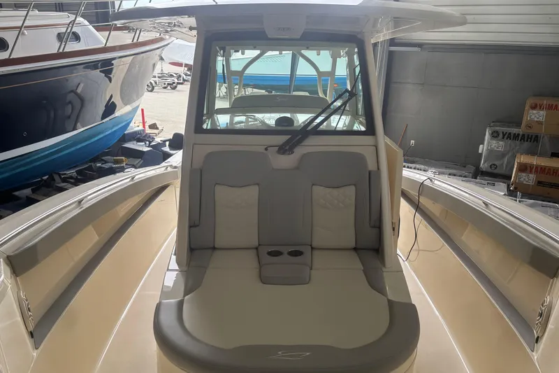 Slide: The Image of 2026 Scout 330 LXF boat interior with cushioned seating and modern design. - 20