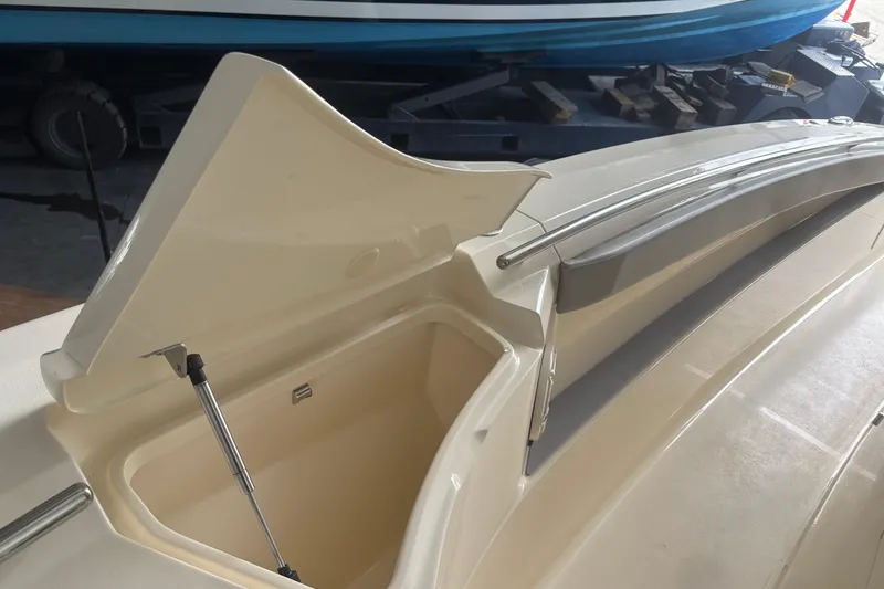 Slide: The Image of Open storage compartment on a 2026 Scout 330 LXF boat, showcasing interior space. - 23