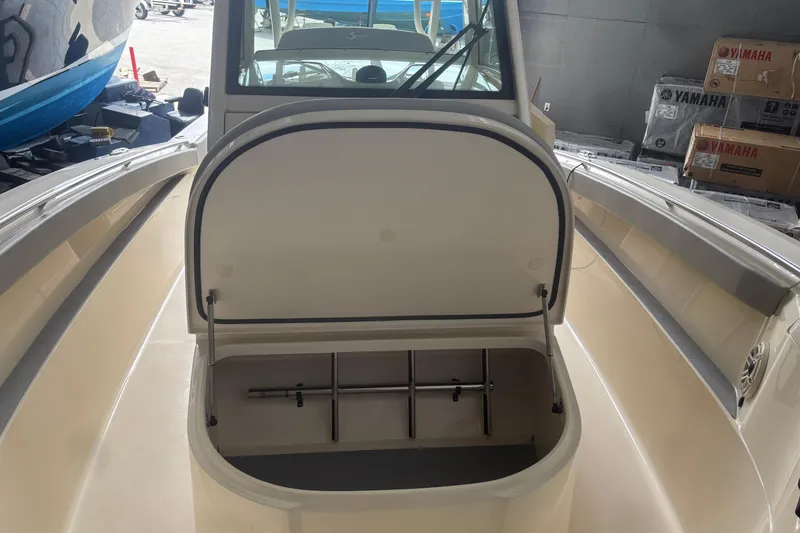 Slide: The Image of 2026 Scout 330 LXF boat interior with open storage compartment. - 21