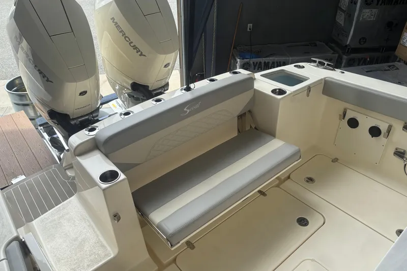 Slide: The Image of 2026 Scout 330 LXF boat interior with Mercury engines and seating area. - 10