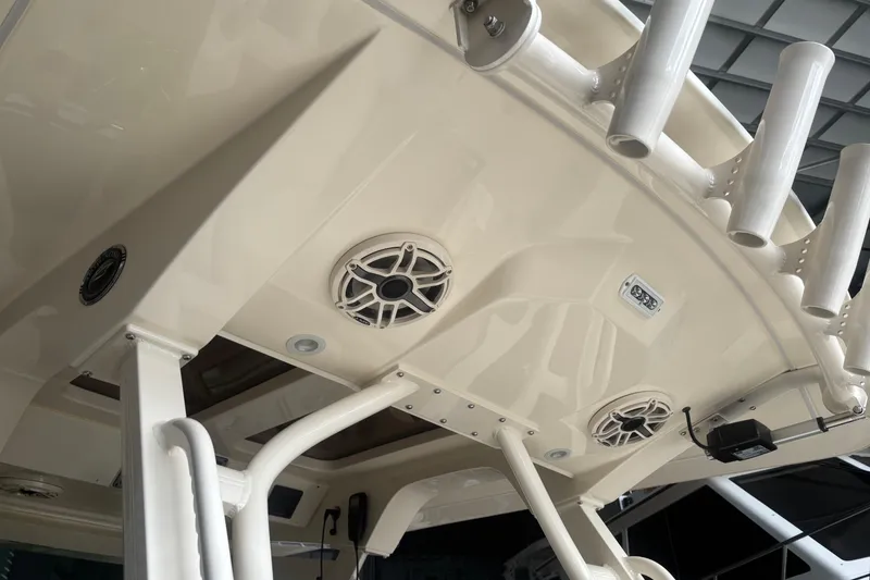 Slide: The Image of 2026 Scout 330 LXF boat interior with speakers and rod holders. - 15